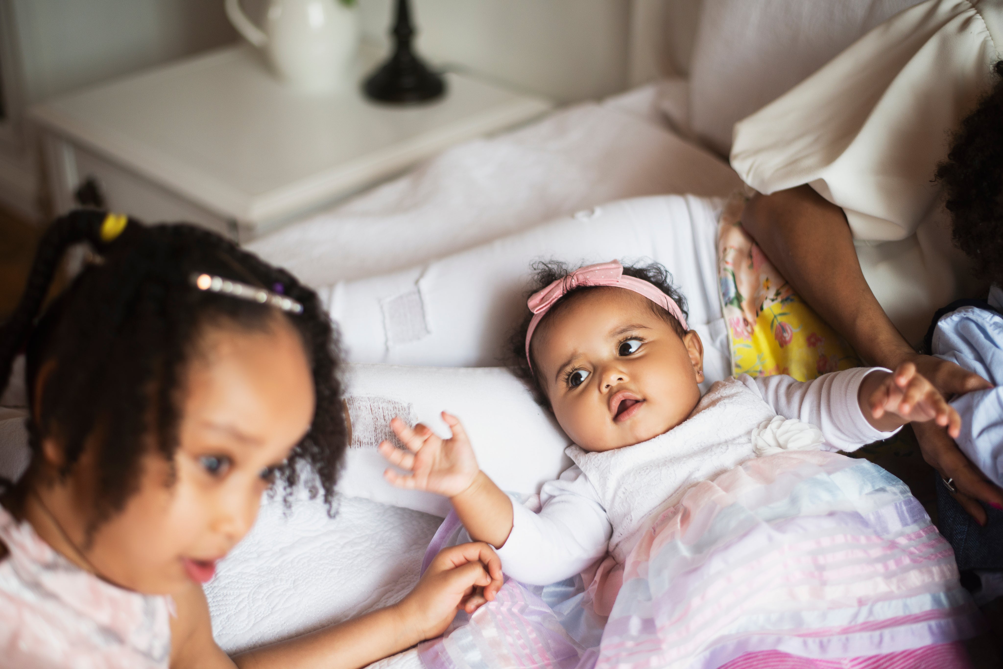 files/baby-reaches-for-her-sister.jpg